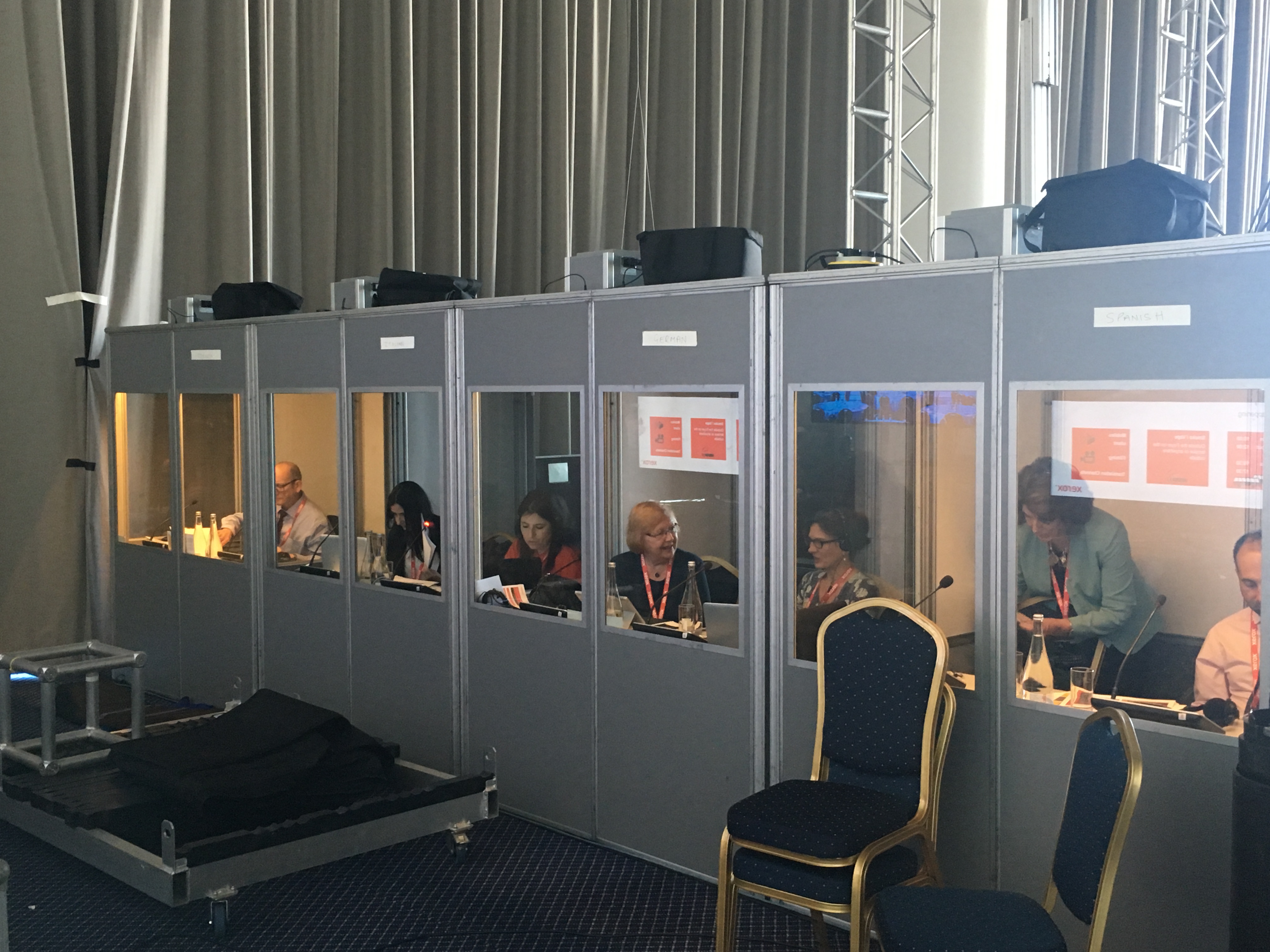 Interpreters at work in soundproof booths backstage at Xerox event in Portugal